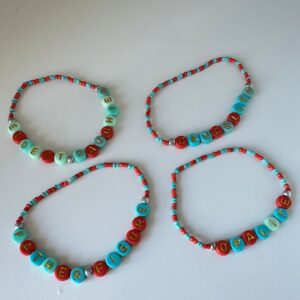 taylor swift showgirl friendship bracelets in teal and orange colours